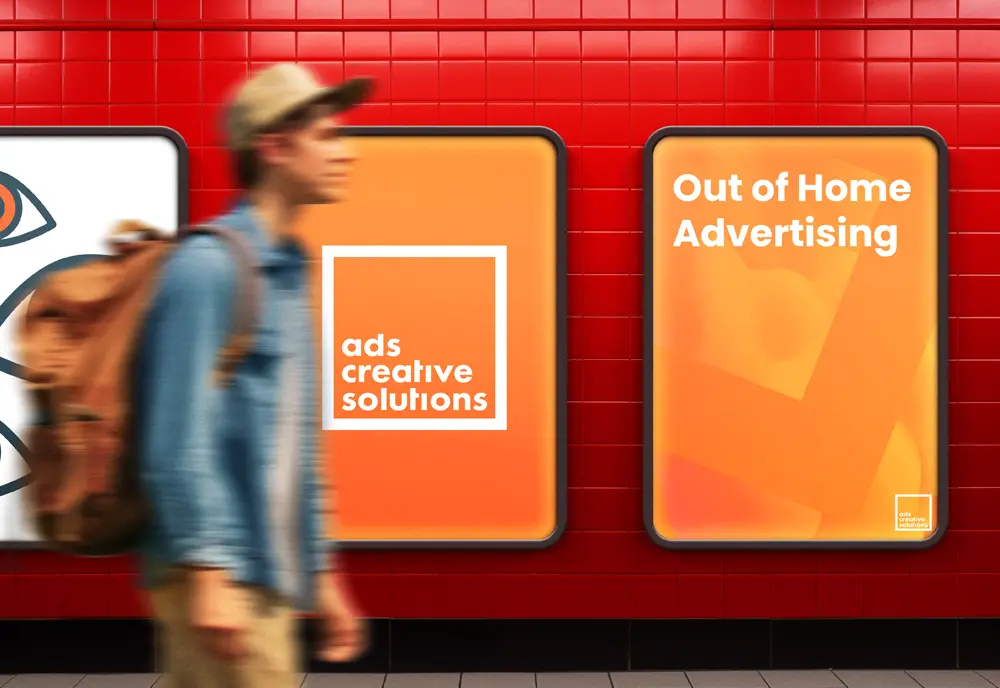 ooh_under Man walking past orange billboards